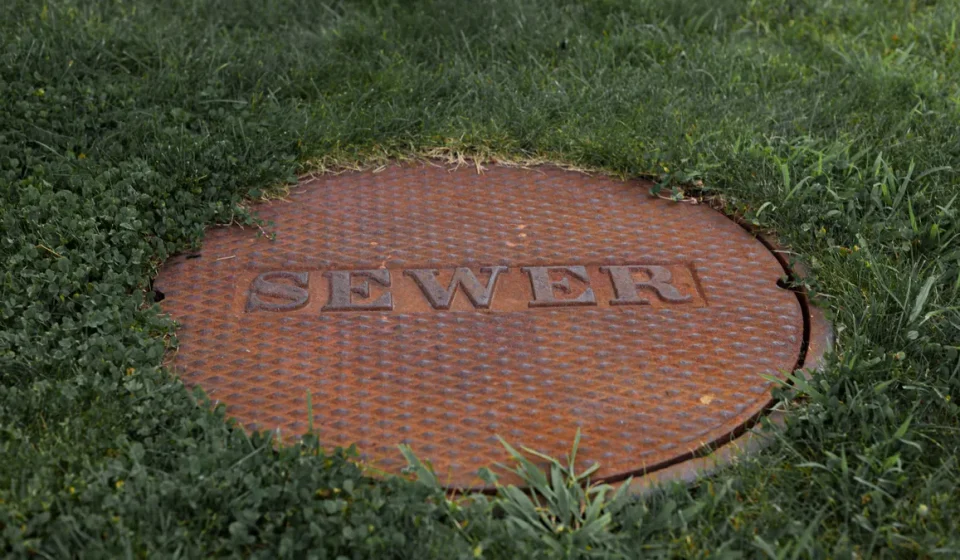 sewer manhole cover in grass