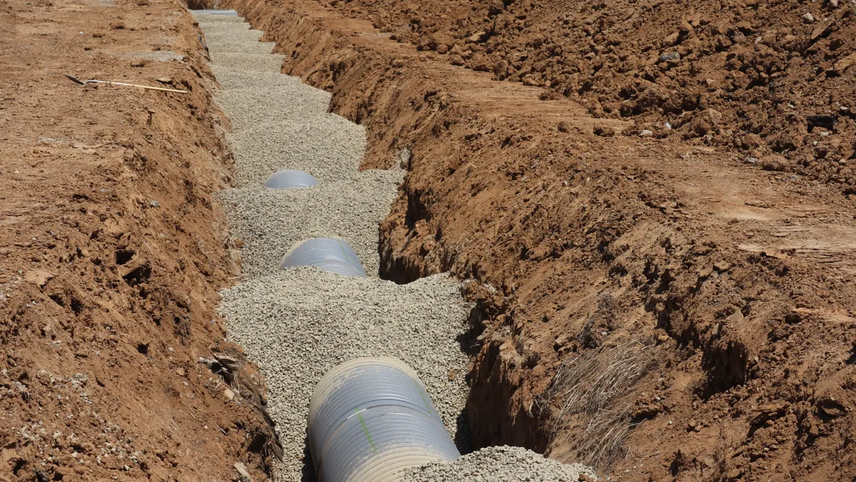Buried drainage pipe in a gravel trench