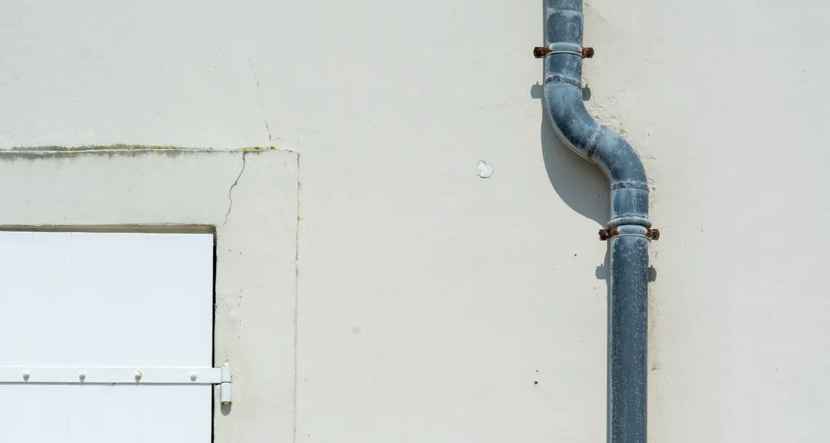 Downspout pipe on a building wall