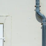 Downspout pipe on a building wall