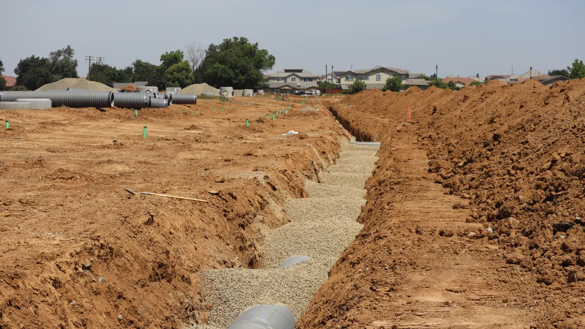 Long drainage trench with gravel and pipe