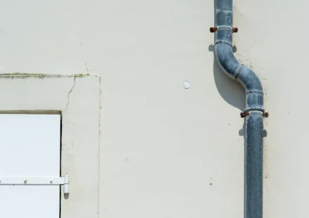 Downspout pipe on a building wall