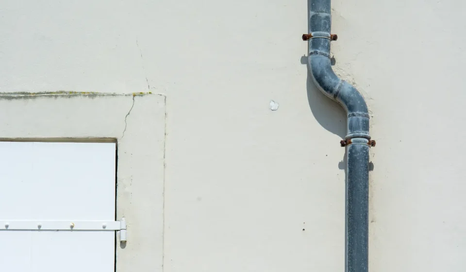 Downspout pipe on a building wall