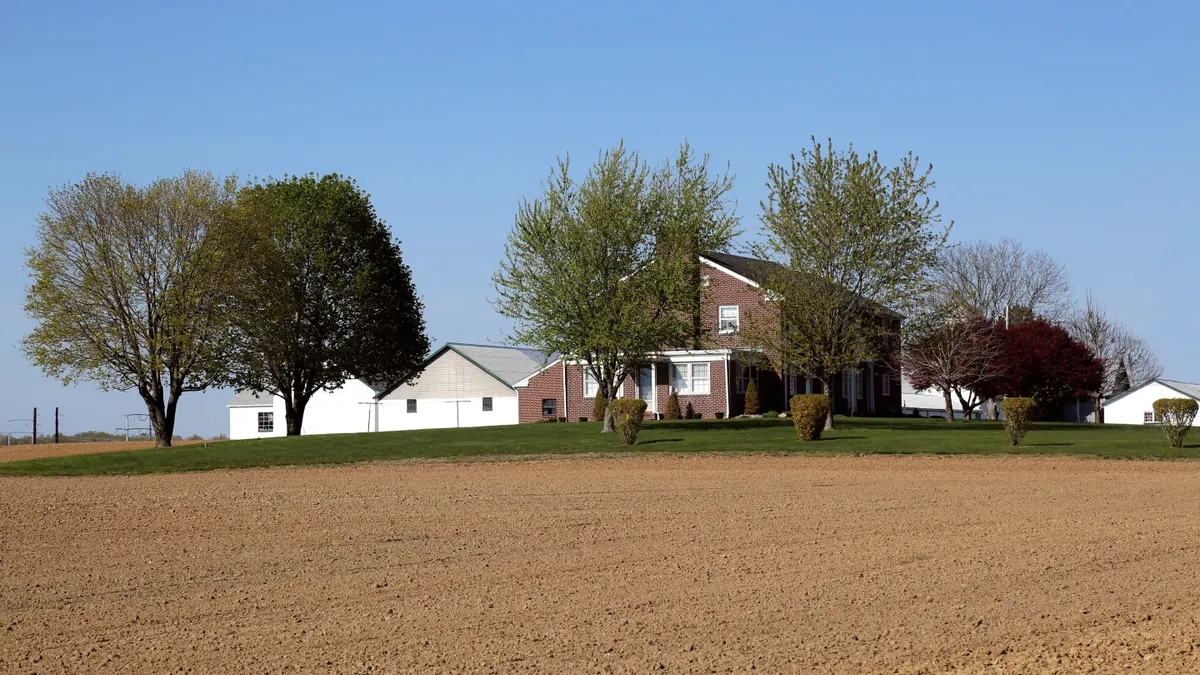 Septic System Landscaping & Surface Protection — The Complete Guide Rural house beside a bare open field
