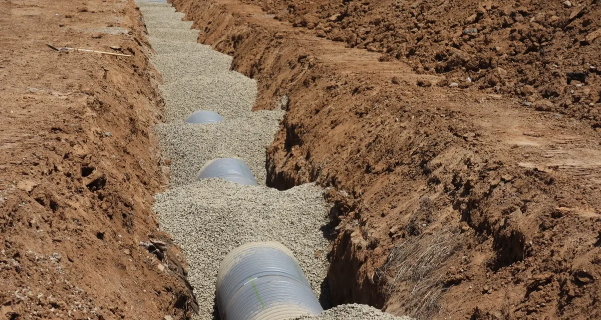 Septic-style drain pipe laid in gravel trench
