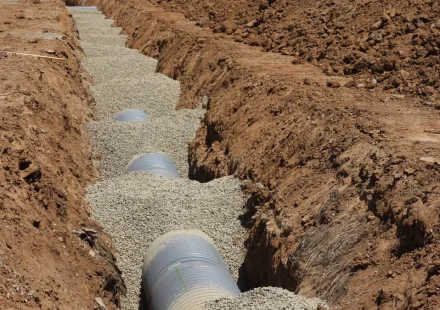 Septic-style drain pipe laid in gravel trench