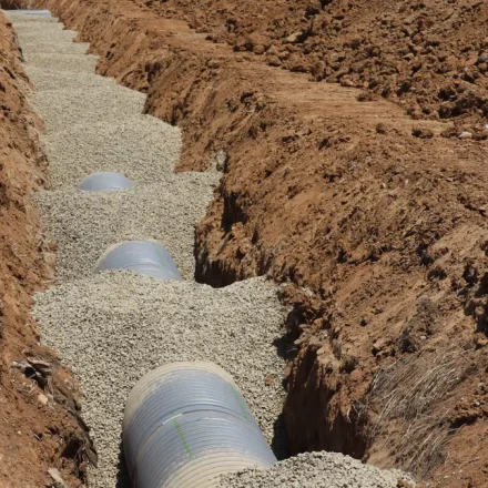Septic-style drain pipe laid in gravel trench