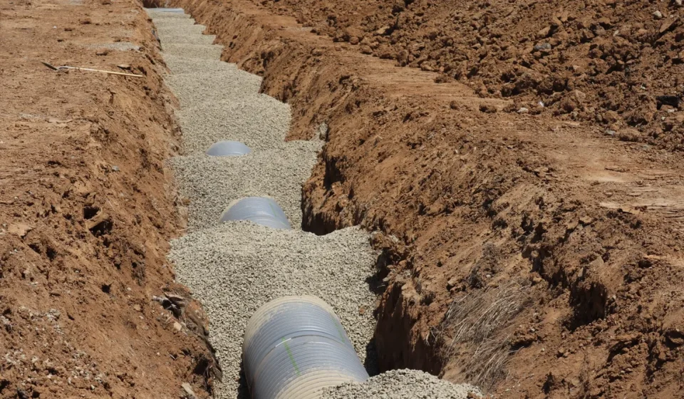 Septic-style drain pipe laid in gravel trench